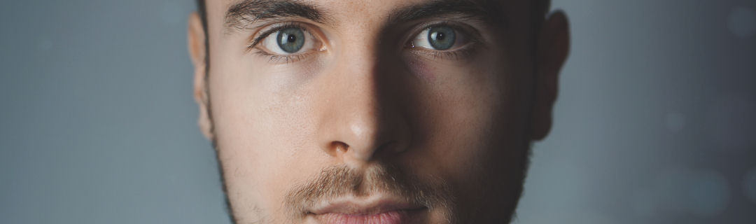 Image of young man gazing intently at camera