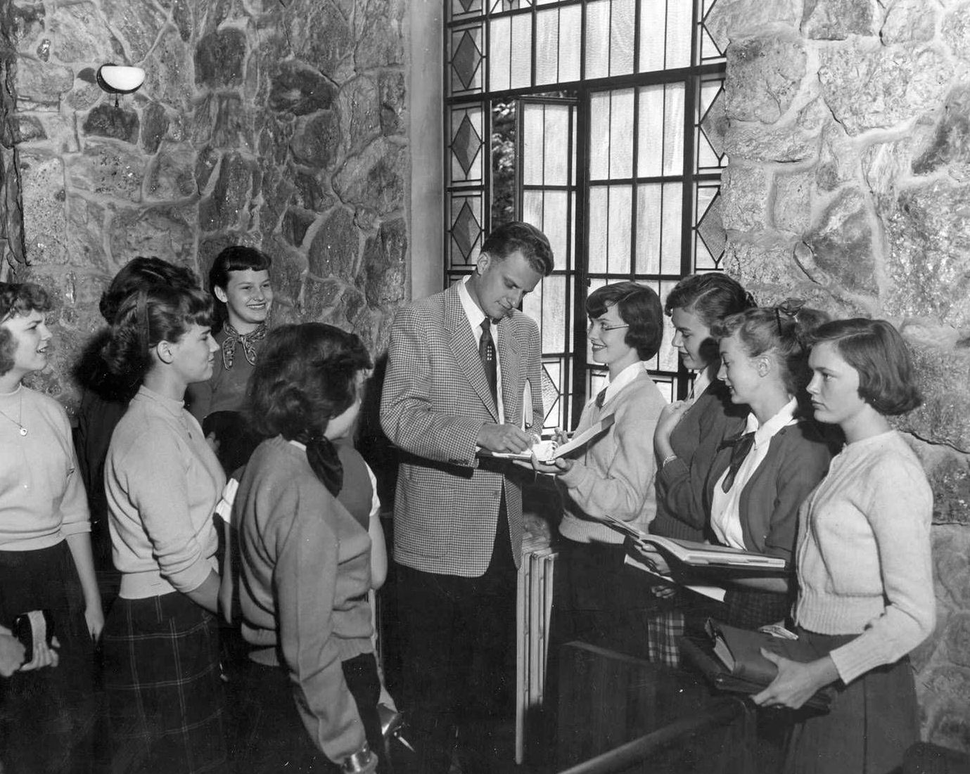 Rev. Billy Graham talks to Montreat College students after chapel in the 1950s