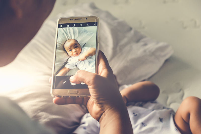 Image of infant viewed through a mobile camera's photo app