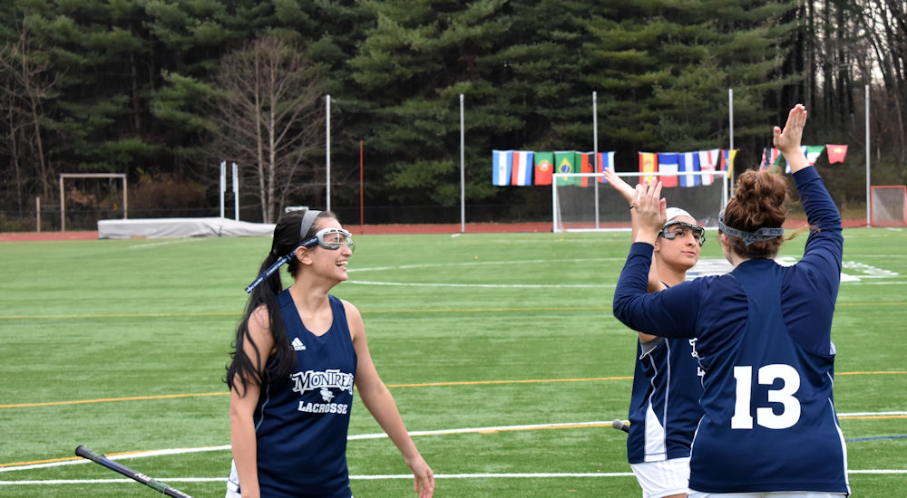 Montreat College lacrosse players high-fiving each other