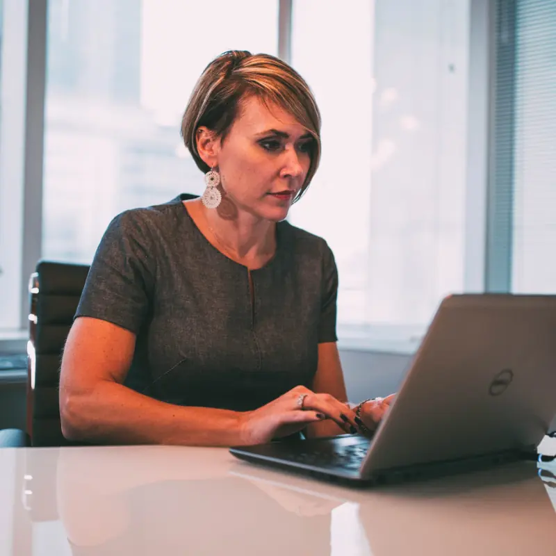Photo of a woman typing on a laptop