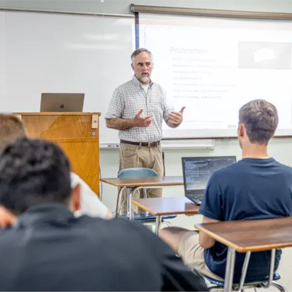 Photo of a professor lecturing in a classroom