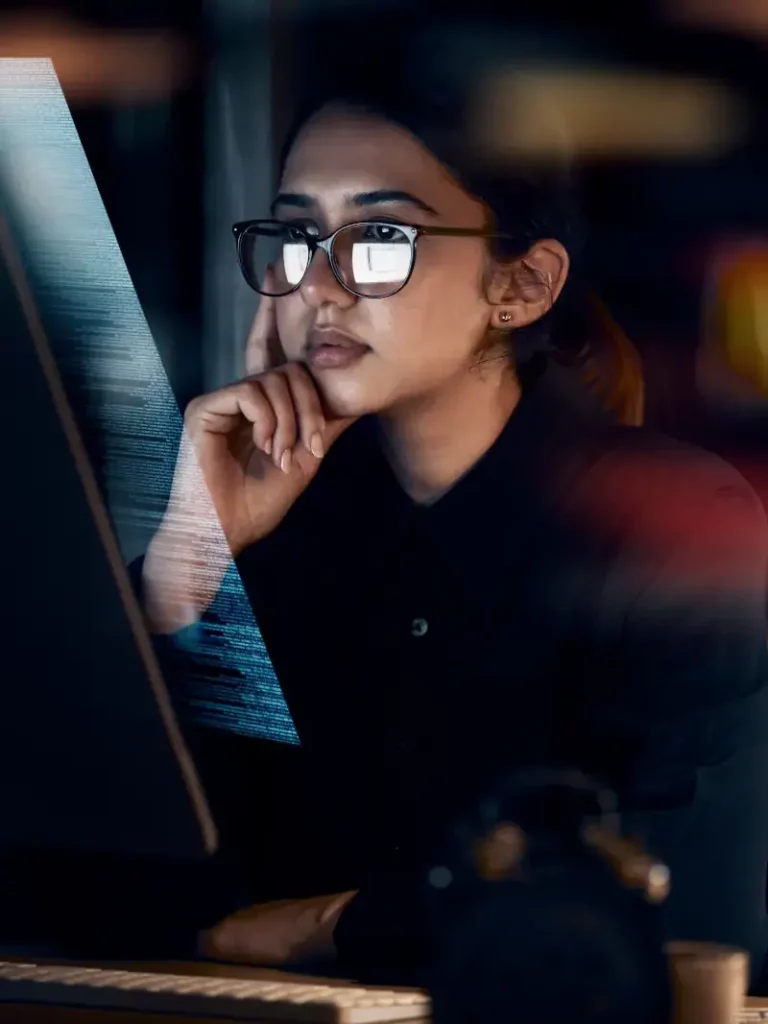 Photo of a young woman looking at a computer screen