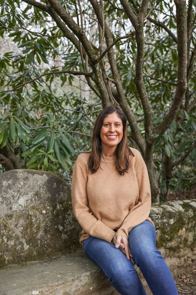 Michelle Coleman sits on a stone bench