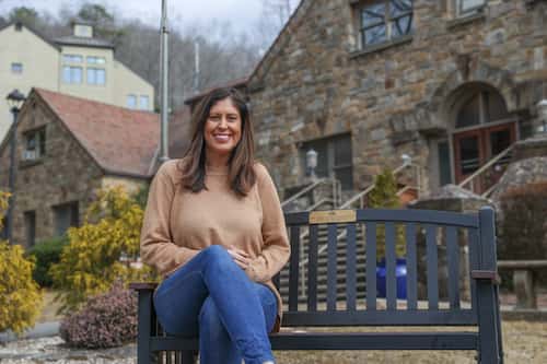 Michelle Coleman sits on a bench outside of Gaither Hall