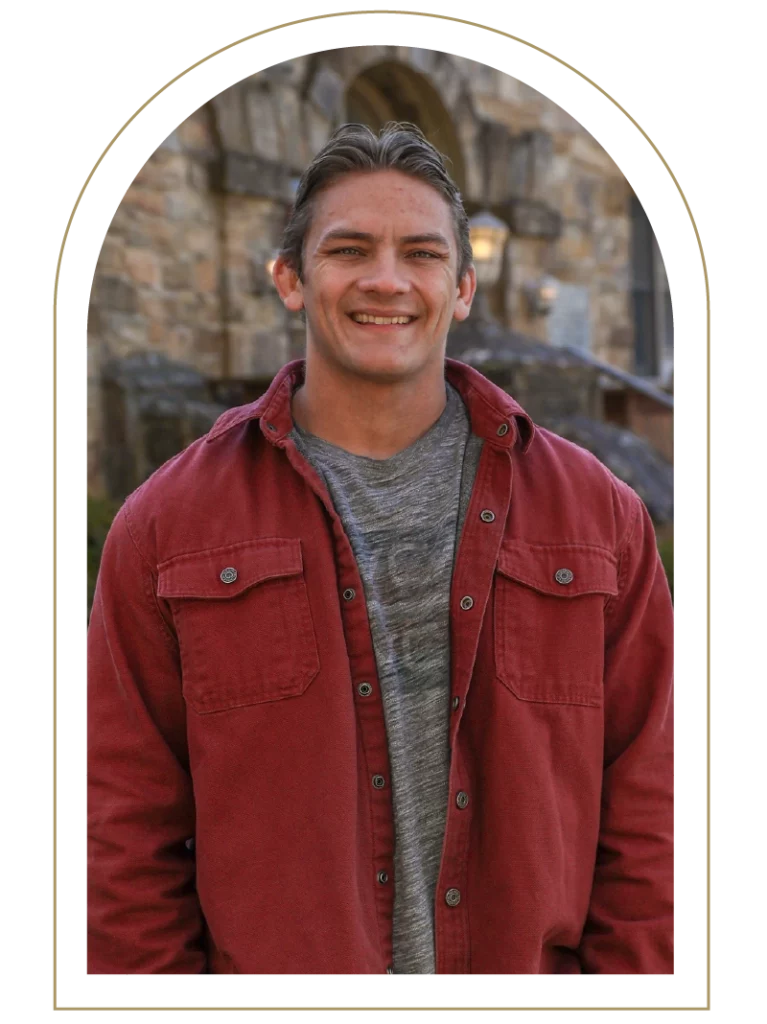 Portrait of a young man wearing a gray shirt and red jacket