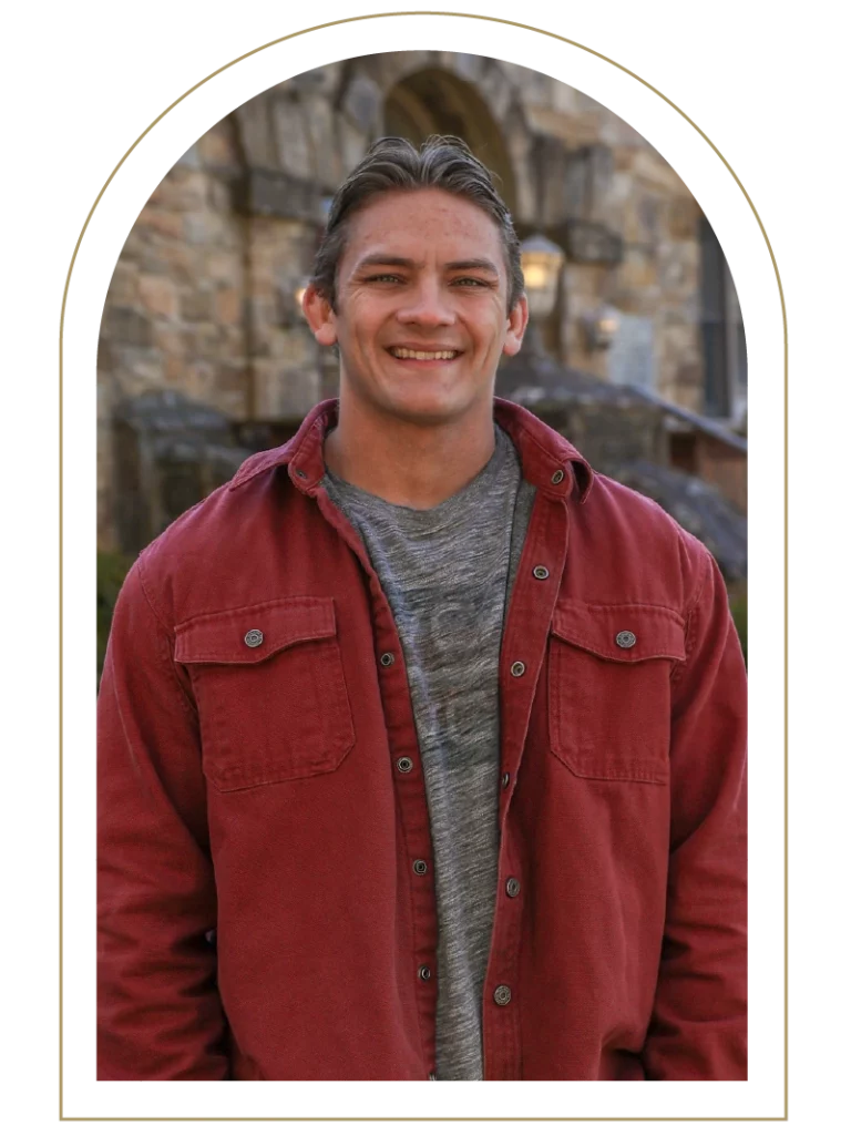 Portrait of a young man wearing a gray shirt and red jacket
