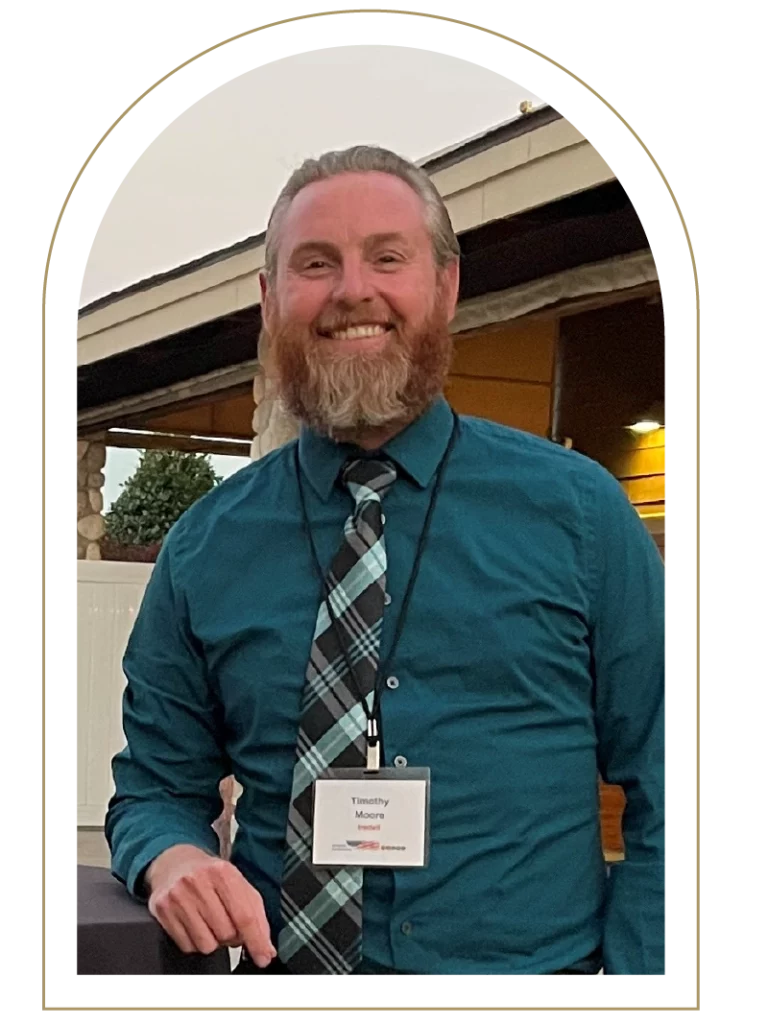Photo of a man with a red beard and turquoise shirt