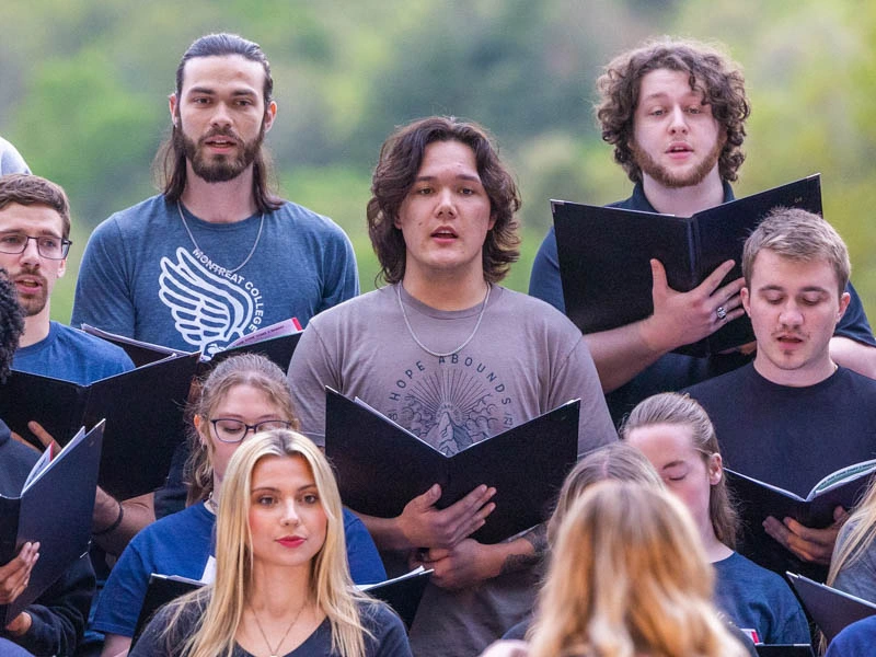 Young men and women sing in a college choir