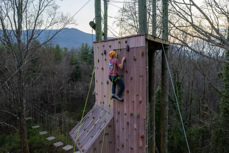 A student climbing the climbing tower at Montreat College's Black Mountain campus