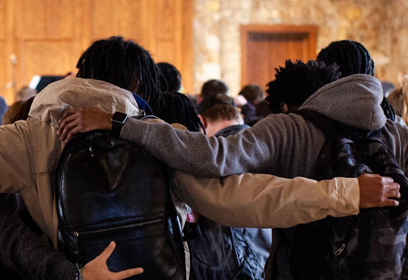 Students holding arms in Graham Chapel
