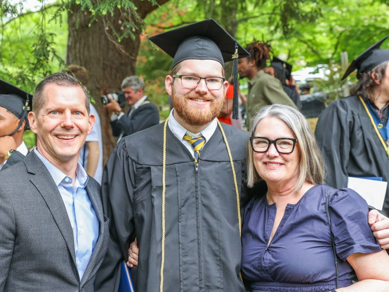 A graduating male student and his parents