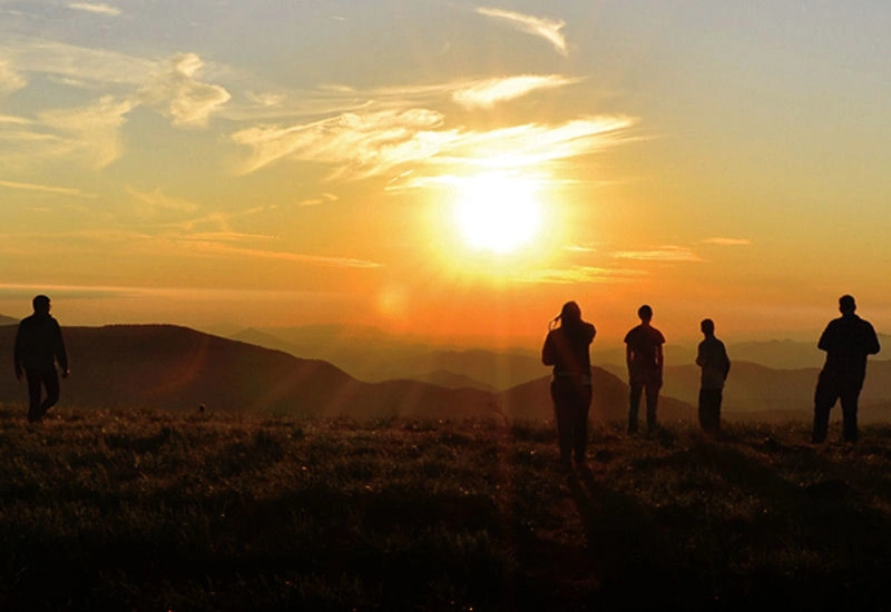 Students looking at sunset over the Blue Ridge Mountains
