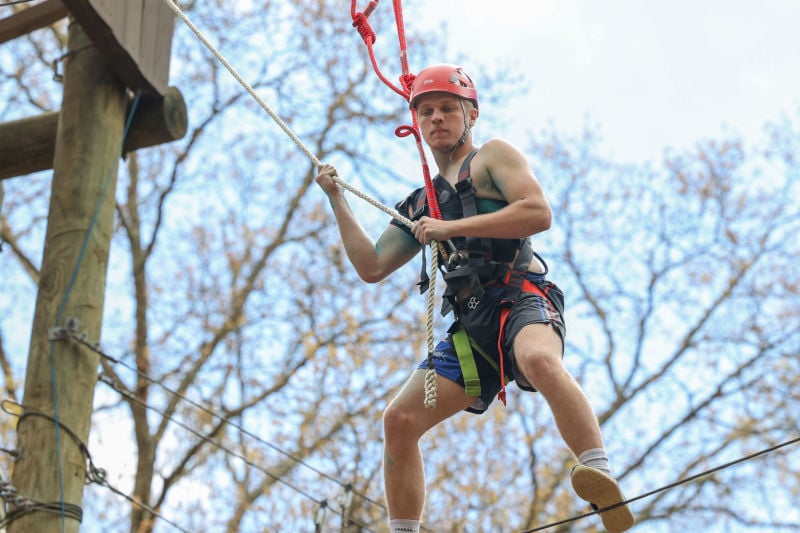 A young man on a high ropes course