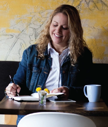 Photo of a woman working at a coffeehouse