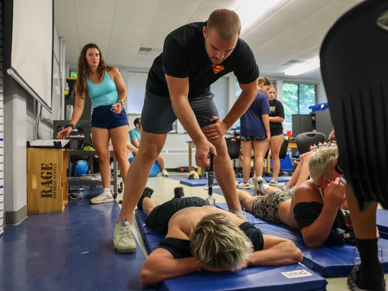 A young man leads an exercise class