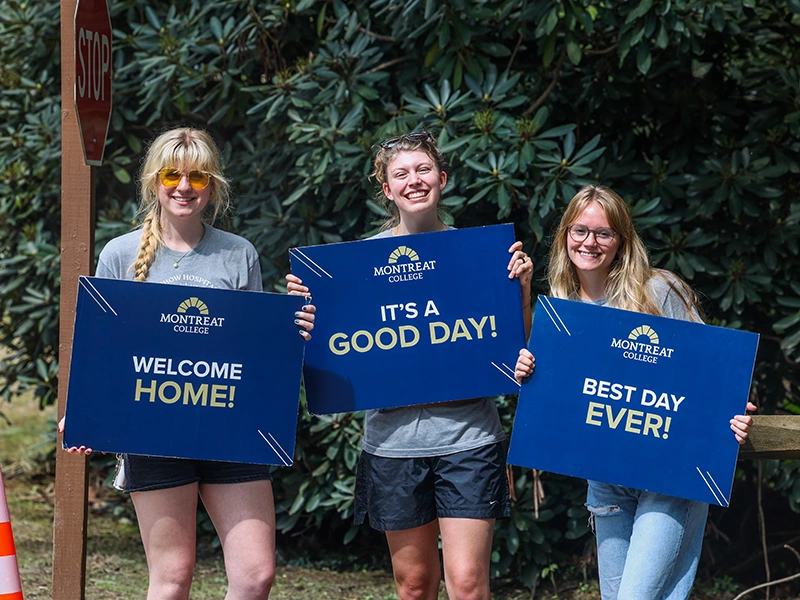 Students holding welcome week signs