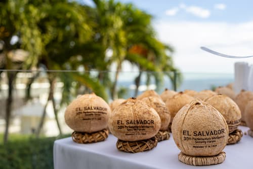 A table of coconuts with the text "El Salvador"