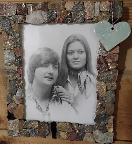 A black and white photo of Rob and Natalie Schermerhorn in a frame