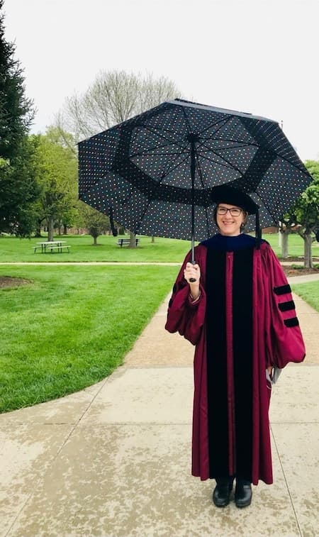 Dorothea Hawthorns holds an umbrella and smiles