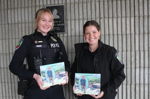 Raquel Smith (left) with Adriana Stewart, holding a children's book