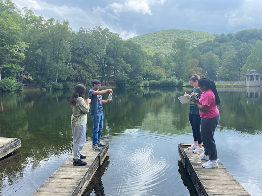 Four students on the Lake Susan docks