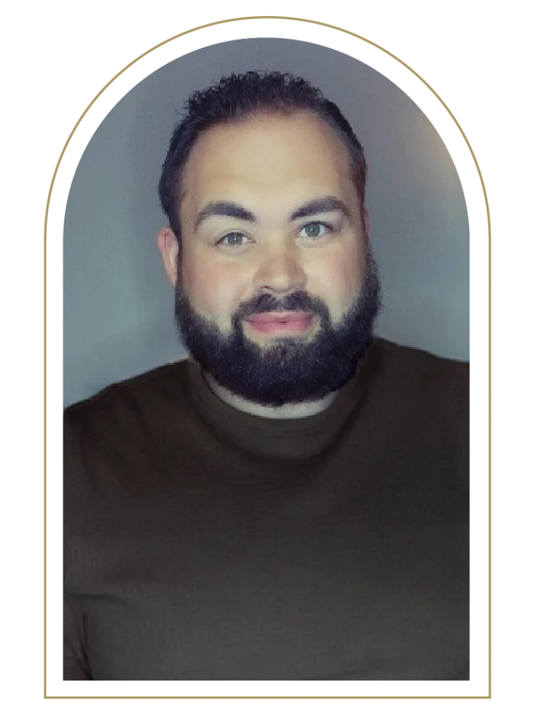 Photo of a middle-aged man with a black beard in a brown shirt